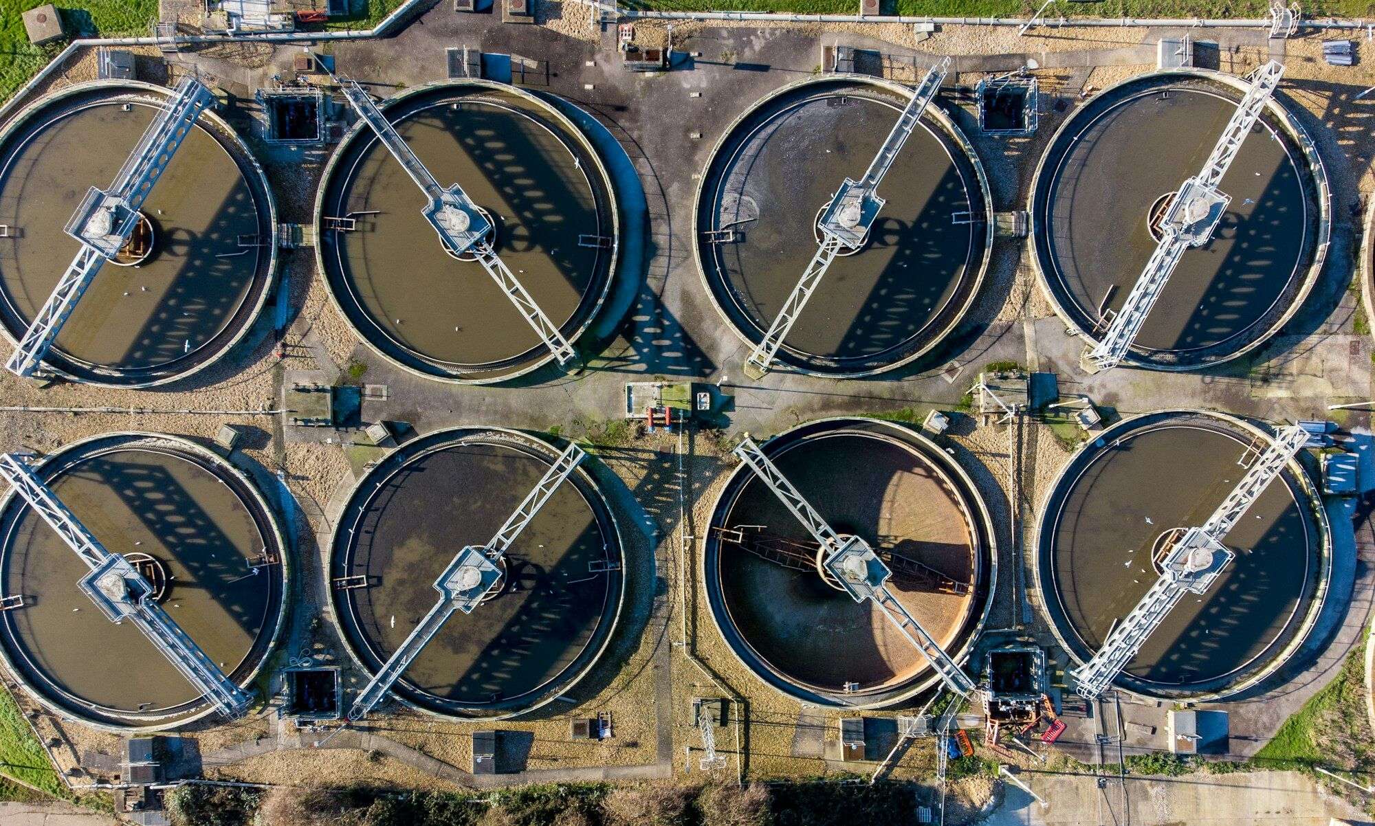 Aerial view of circular clarifier tanks at a wastewater treatment plant