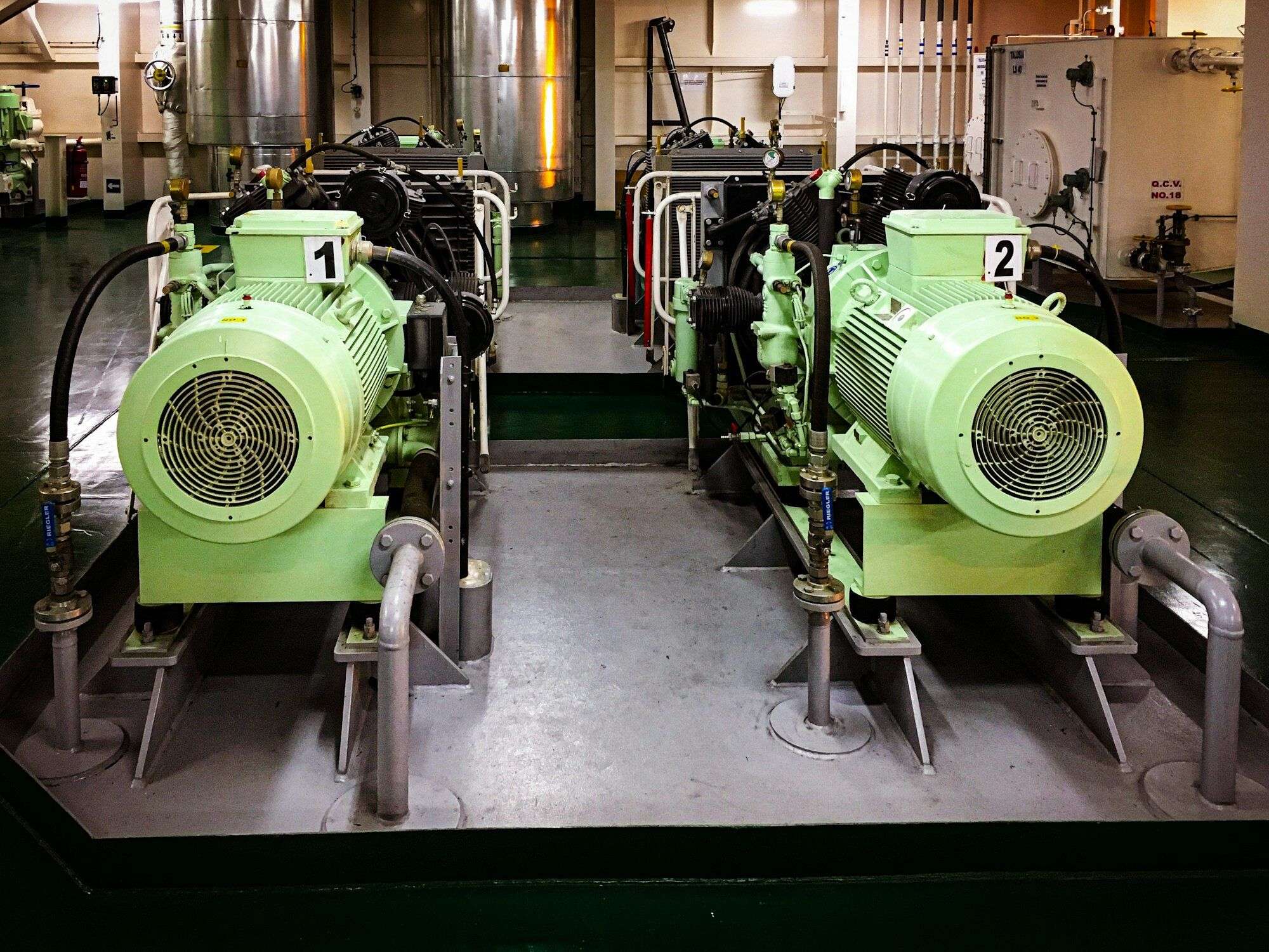 Two motor-driven reciprocating air compressors in a plant room