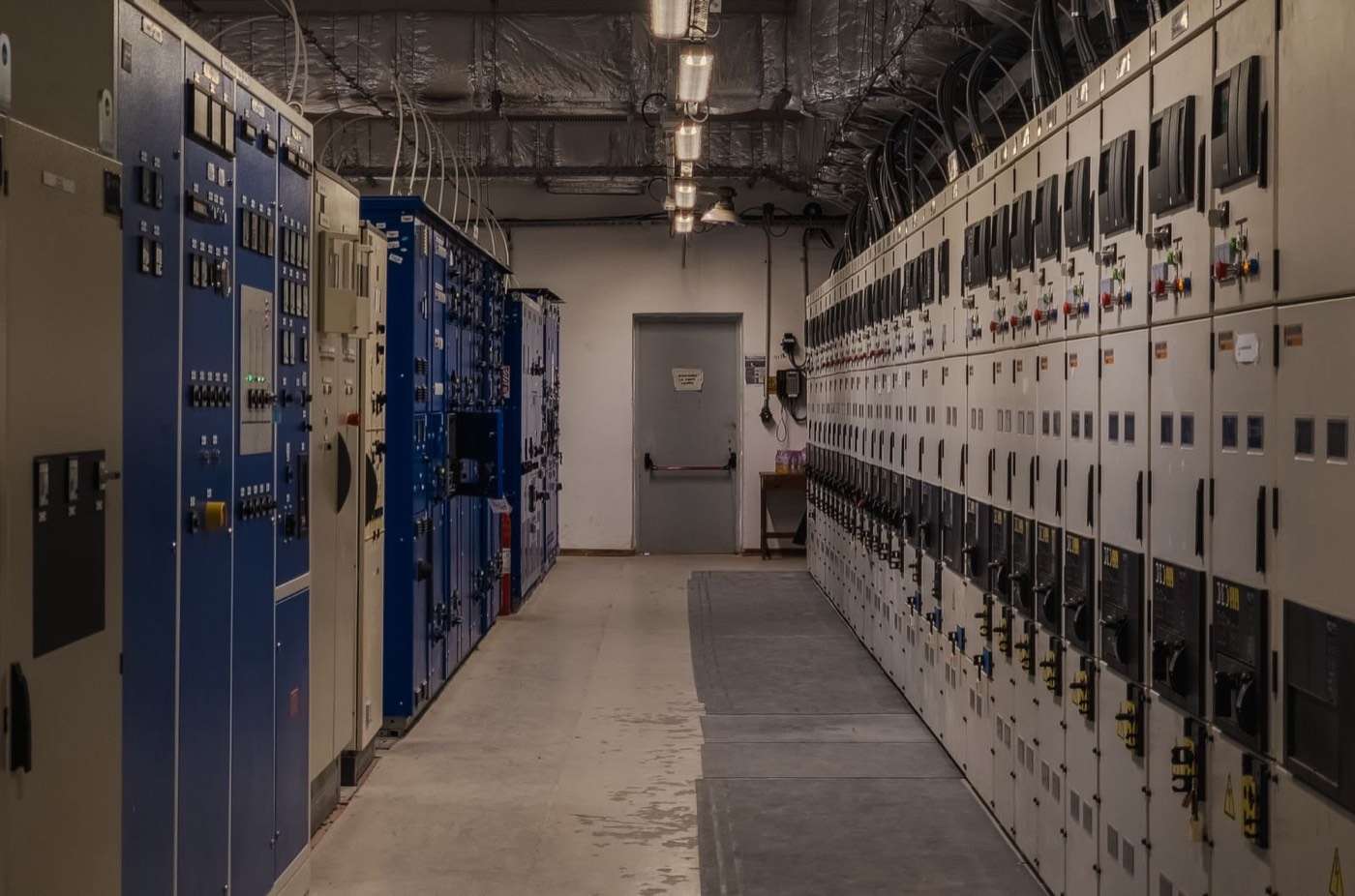 Long switchroom lined with motor control and switchgear panels
