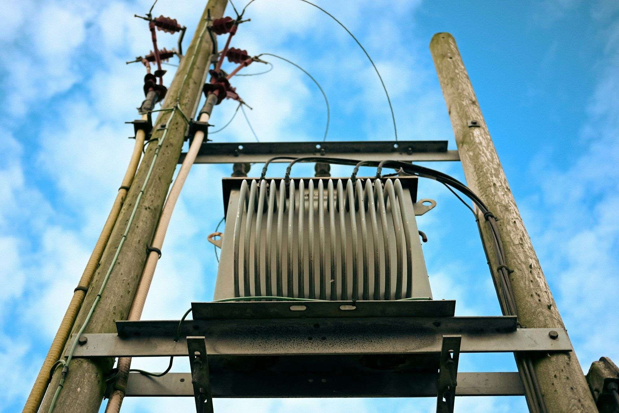 Pole-mounted electricity supply transformer seen from below